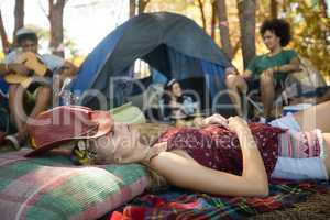 Young woman sleeping while friends sitting in background