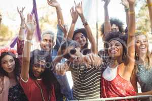 Portrait of cheerful friends enjoying during music festival