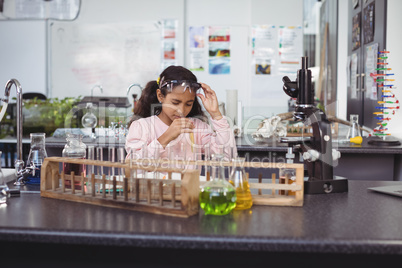 Elementary student holding test tube at laboratory