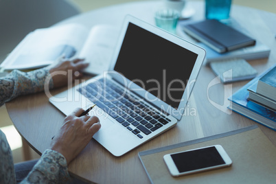 High angle view of businesswoman using laptop
