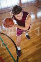 High angle view of male player practicing basketball