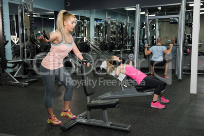 Man and woman exercising in gym