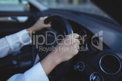 Cropped image of businesswoman in car