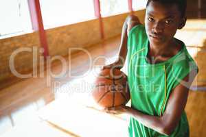 Portrait of teenage boy holding basketball