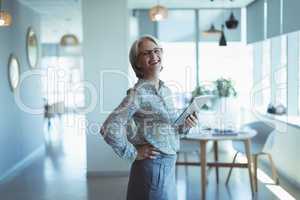 Portrait of smiling businesswoman with tablet computer