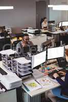 Coworkers working at their desk in office