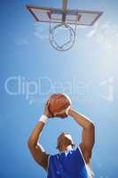 Directly below shot of teenage boy playing basketball