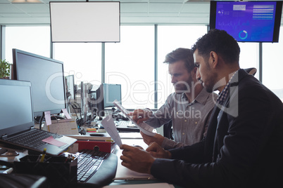 Focused male business colleagues working together in office