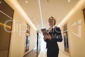 Businesswoman standing in corridor