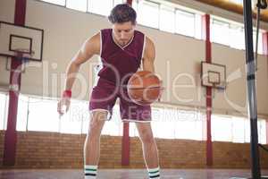 Male player practicing basketball