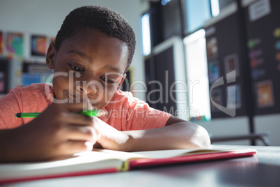 Boy writing in book