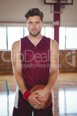 Portrait of man holding basketball