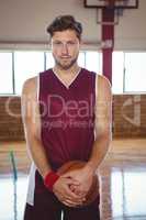 Portrait of man holding basketball