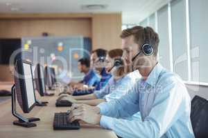Businessman typing on keyboard at call center