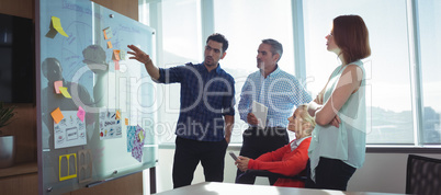 Young businessman discussing with colleagues at office