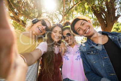 Portrait of smiling friends against trees