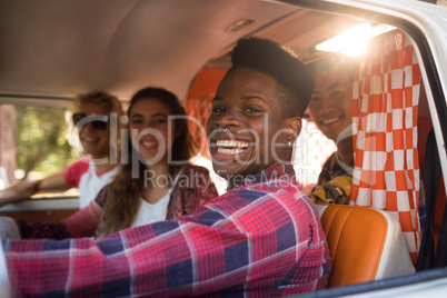 Cheerful friends in camper van