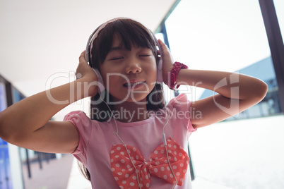 Girl with eyes closed listening music through headphones