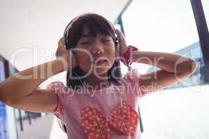 Girl with eyes closed listening music through headphones