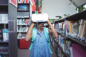 Girl wearing virtual reality simulator in library
