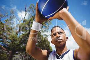Close up of male teenager practicing basketball