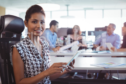 Portrait of businesswoman using digital tablet in office