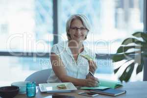 Portrait of businesswoman having food