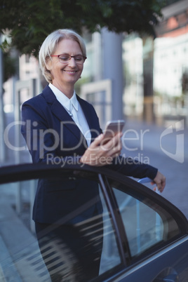 Smiling businesswoman using phone