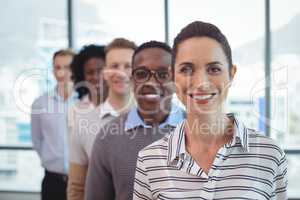 Portrait of smiling business colleagues standing in row