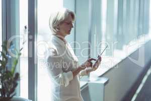 Businesswoman woman using tablet computer by window