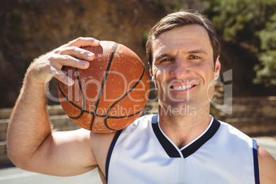 Smiling basketball player with ball