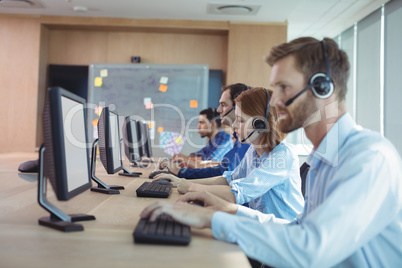 Side view of business people working at call center