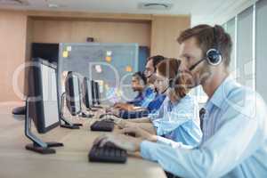 Side view of business people working at call center