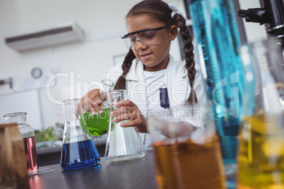 Elementary student doing scientific experiment at laboratory