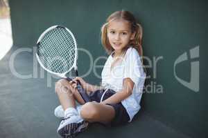 Portrait of girl holding tennis racket