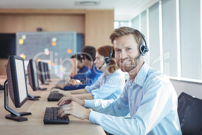 Portrait of smiling businessman working at call center