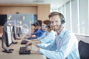 Portrait of smiling businessman working at call center