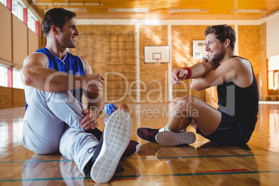 Happy male friends practicing stretching exercise