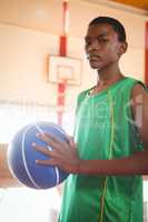 Portrait of teenager with basketball