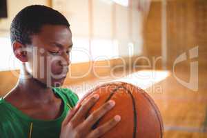 Close up of teenage boy looking at basketball