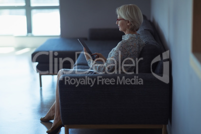 Side view of businesswoman using digital tablet