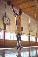 Full length of teenage boy playing basketball