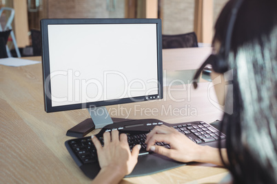 Cropped image of businesswoman working on computer at call center
