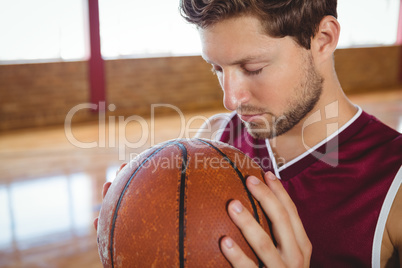 Close up of man with eyes closed holding ball