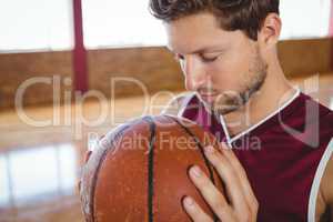 Close up of man with eyes closed holding ball