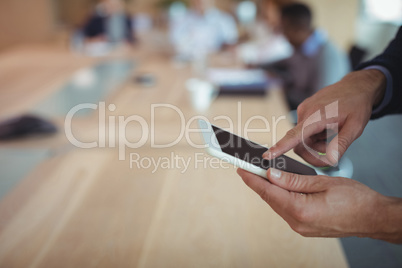 Cropped hands on businessman using digital tablet