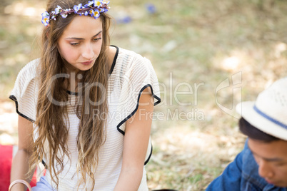 High angle view of woman sitting with friend on field