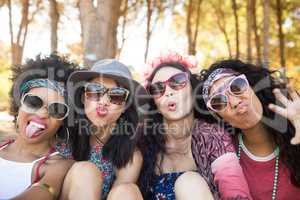 Portrait of happy female friends making faces at campsite