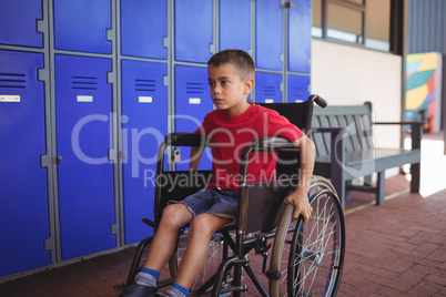 Thoughtful boy sitting on wheelchair