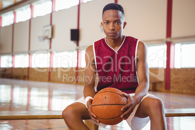 Portrait of confident male teenager in court